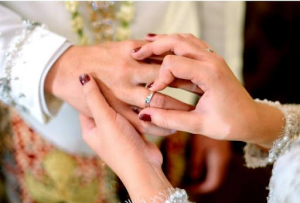 Close-up of couple exchanging wedding rings during ceremony